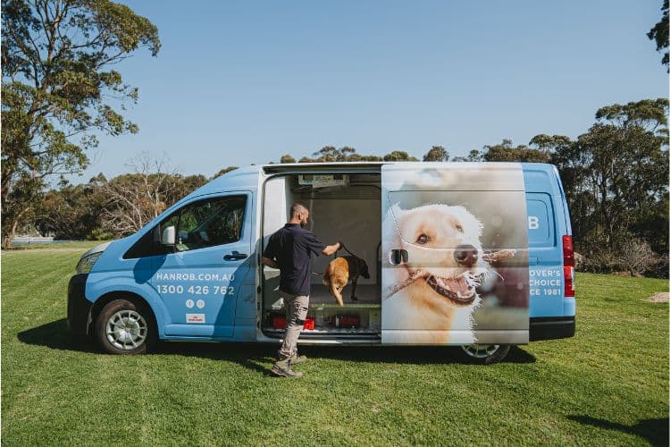 Hanrob Pet Hotels van with a dog being loaded
