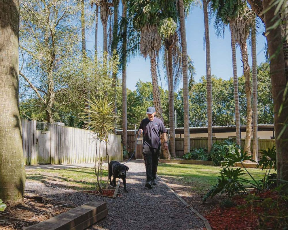Hanrob Pet Hotels staff walking a dog outdoors